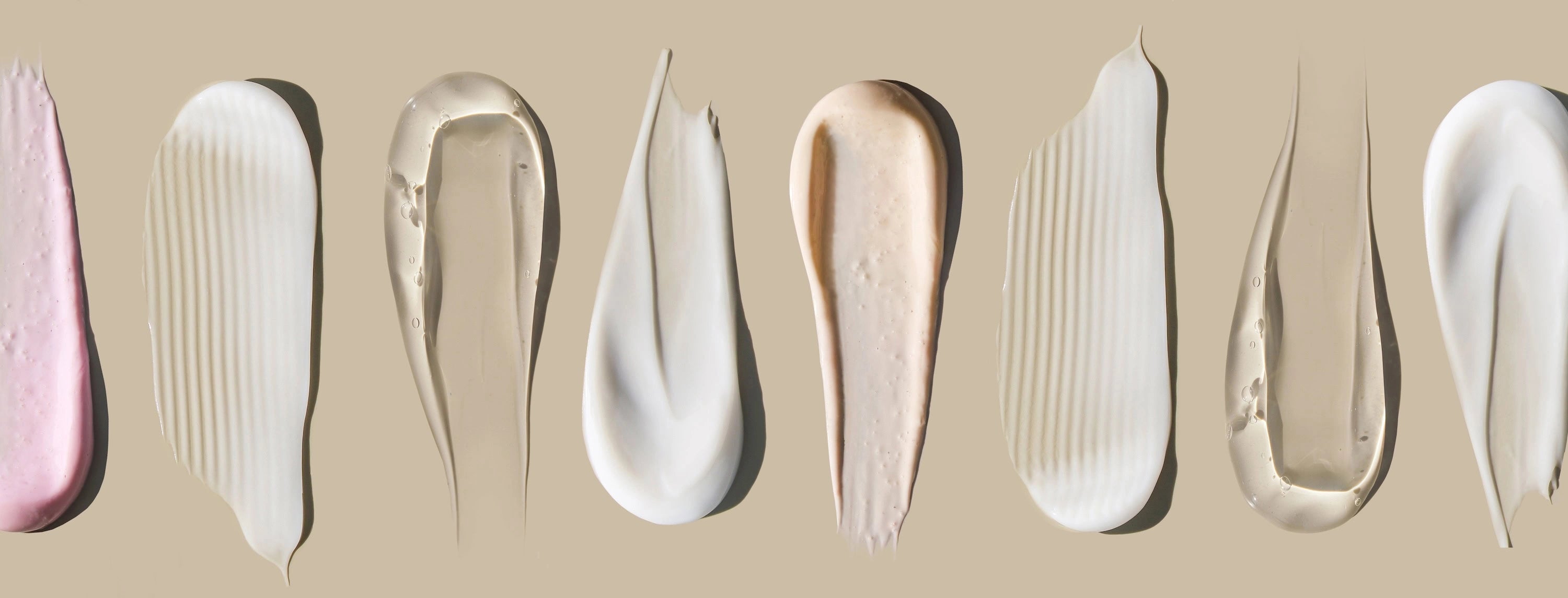 Various swatches of cream on a beige background