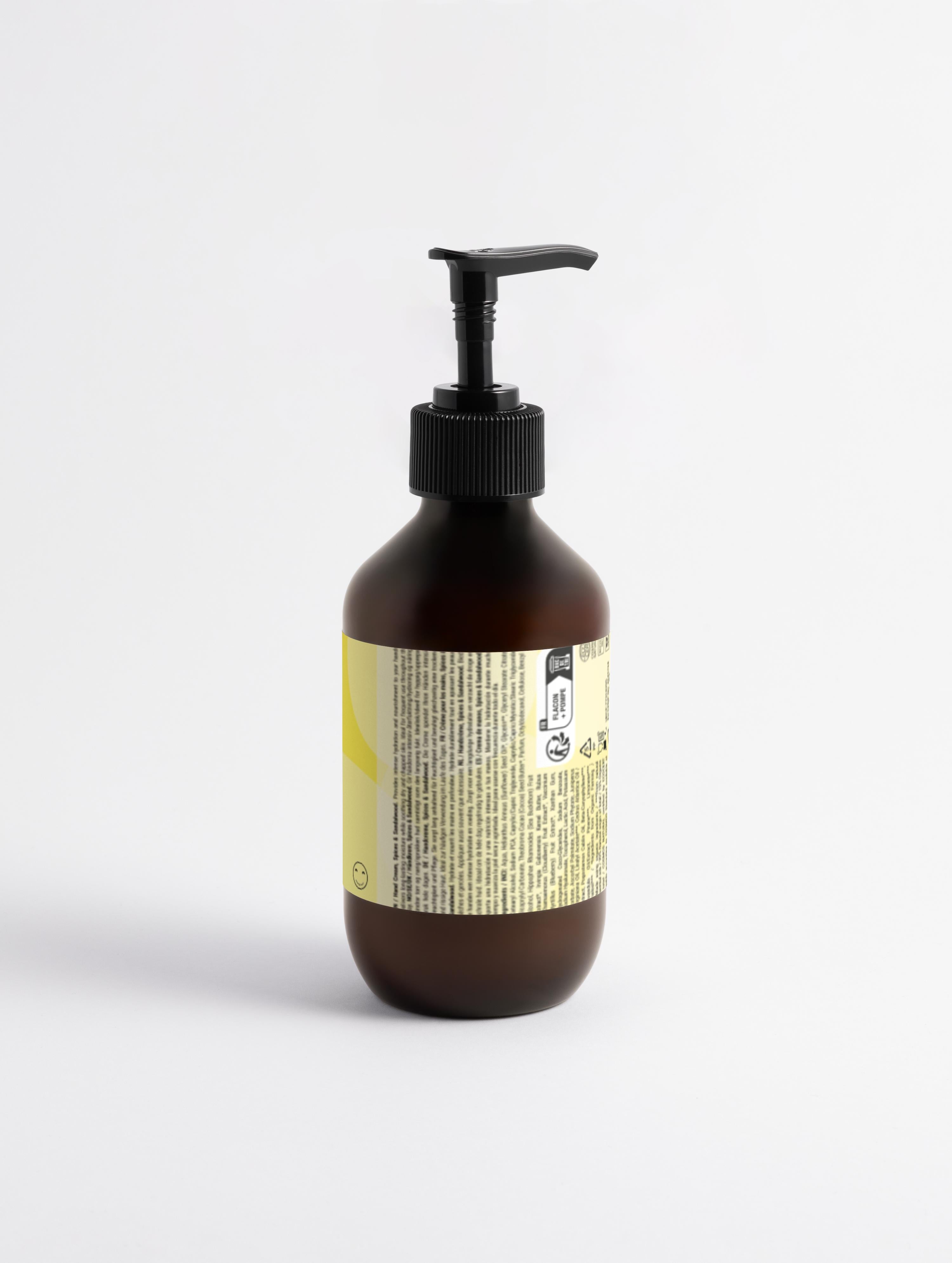 Brown bottle with pump and yellow label on a white background