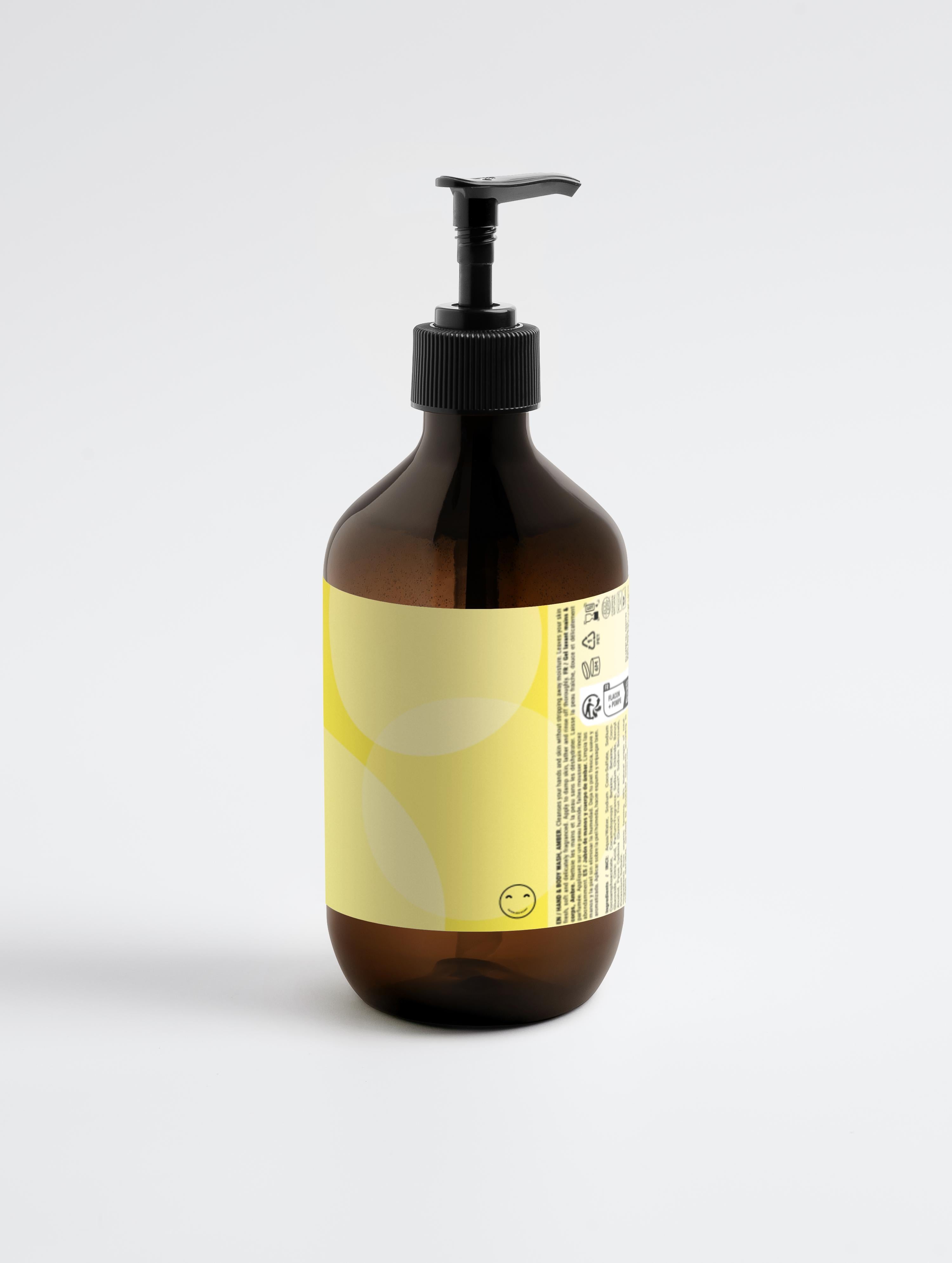 Amber glass bottle with pump and yellow label on a light gray background