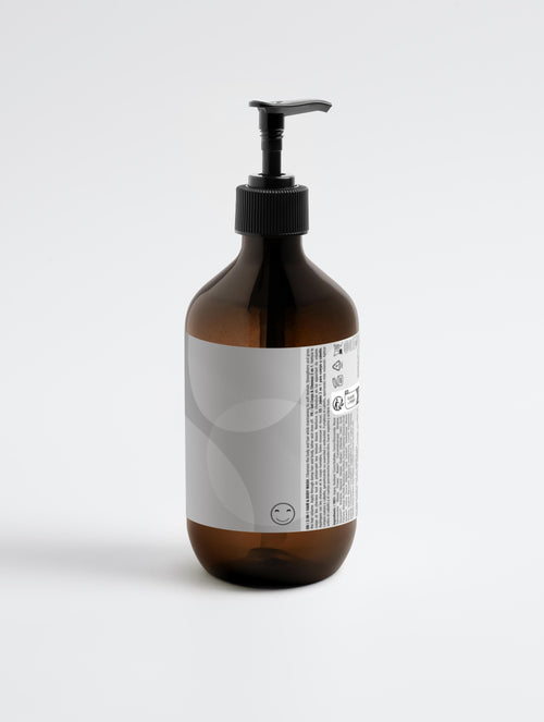 Brown bottle with black pump on a white background