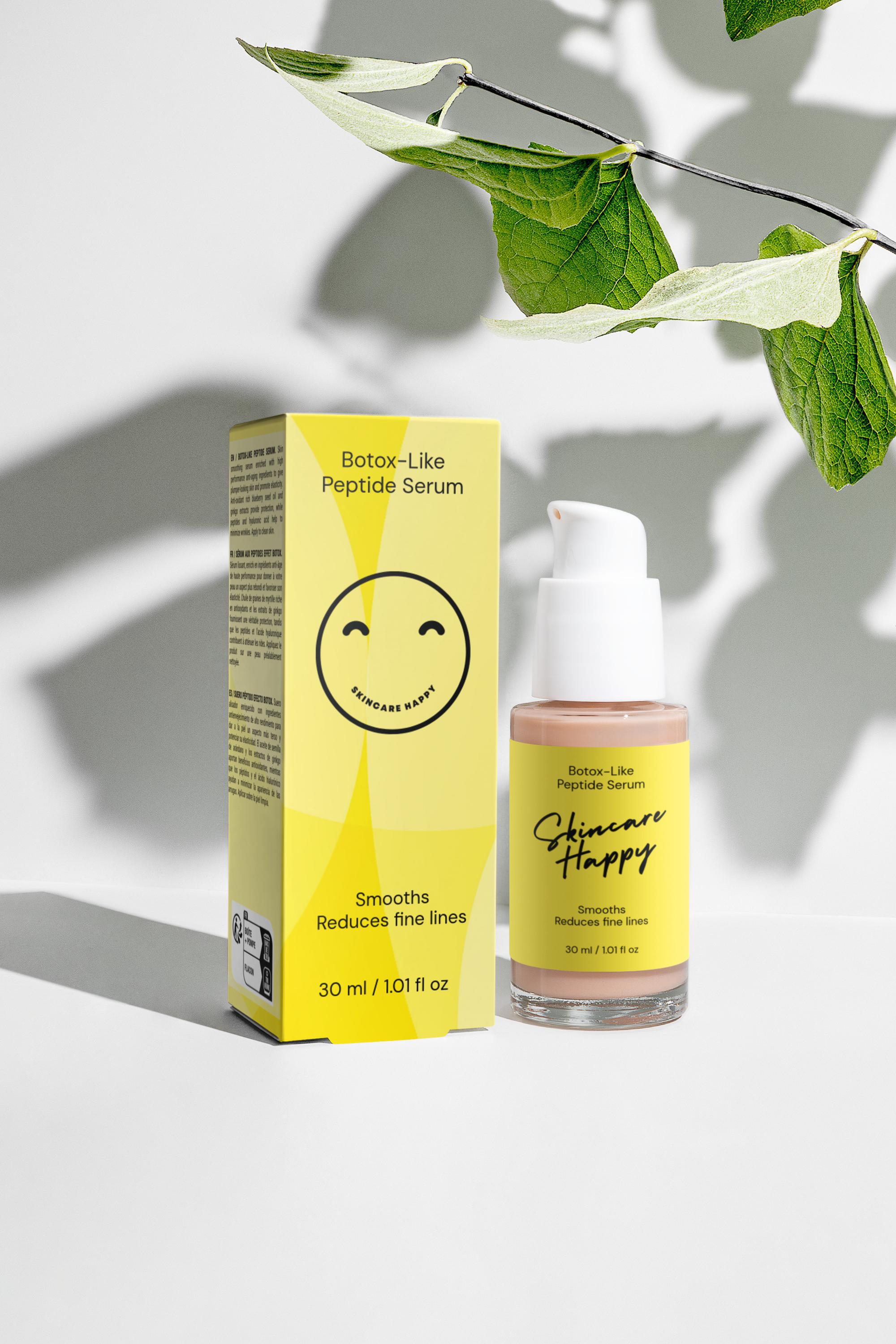 Skincare serum bottle and packaging with a yellow label on a light background