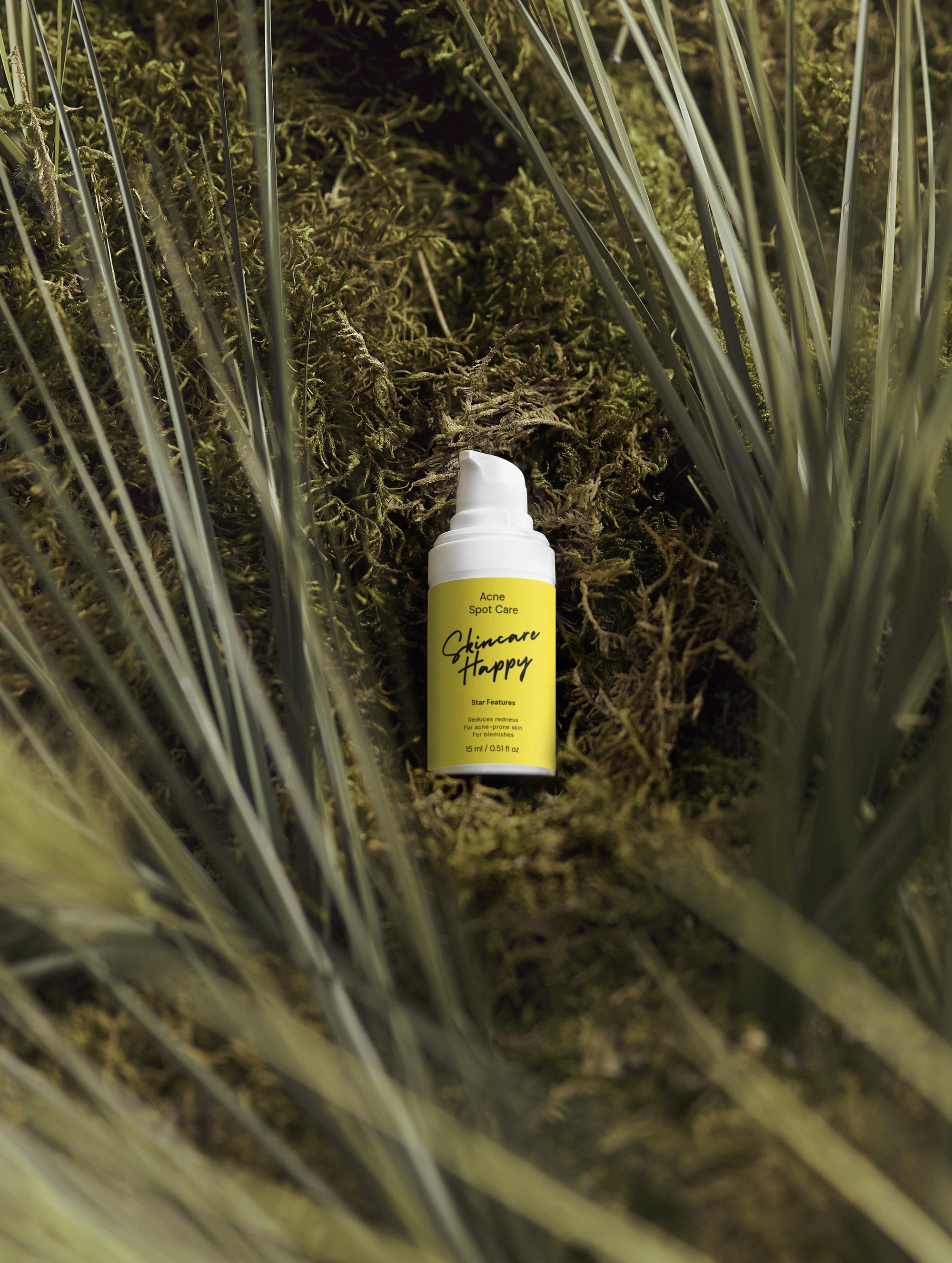 Yellow bottle with white cap on a green leafy background