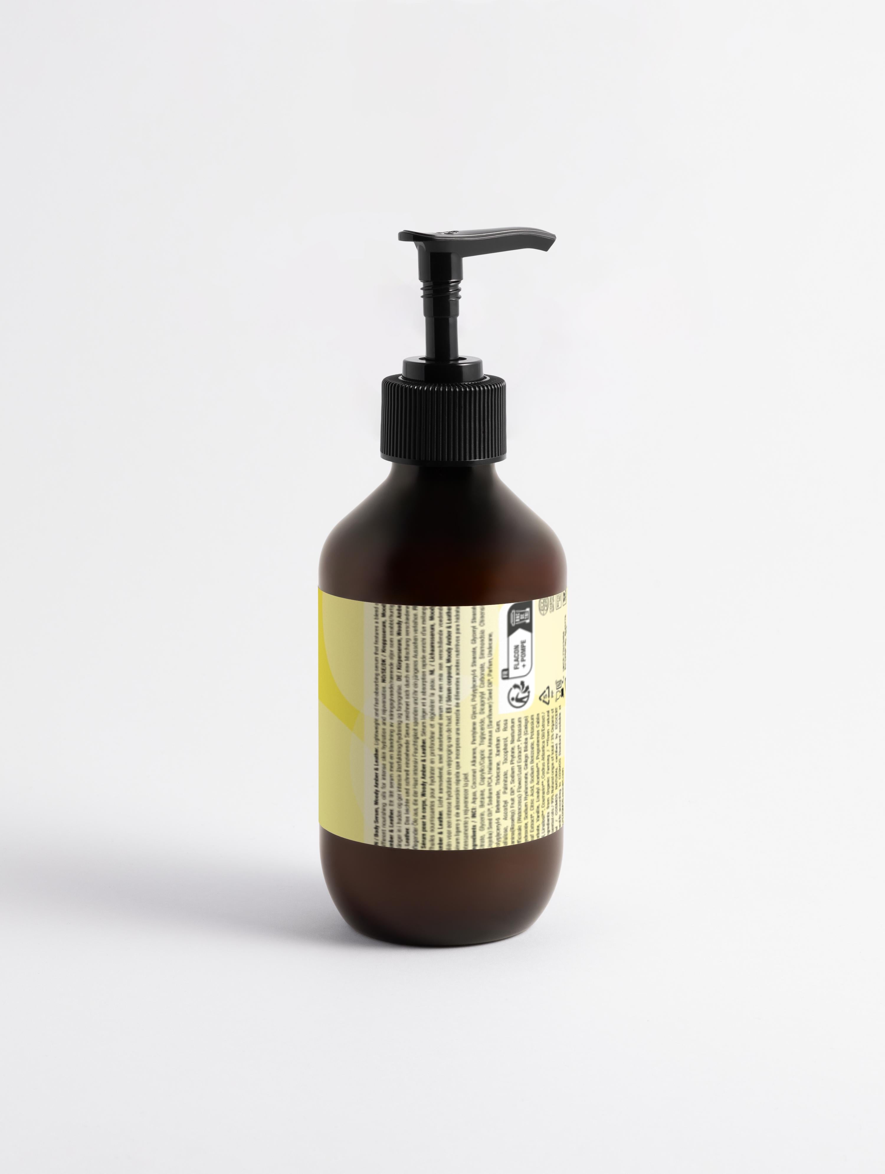 Brown bottle with pump and yellow label on a white background