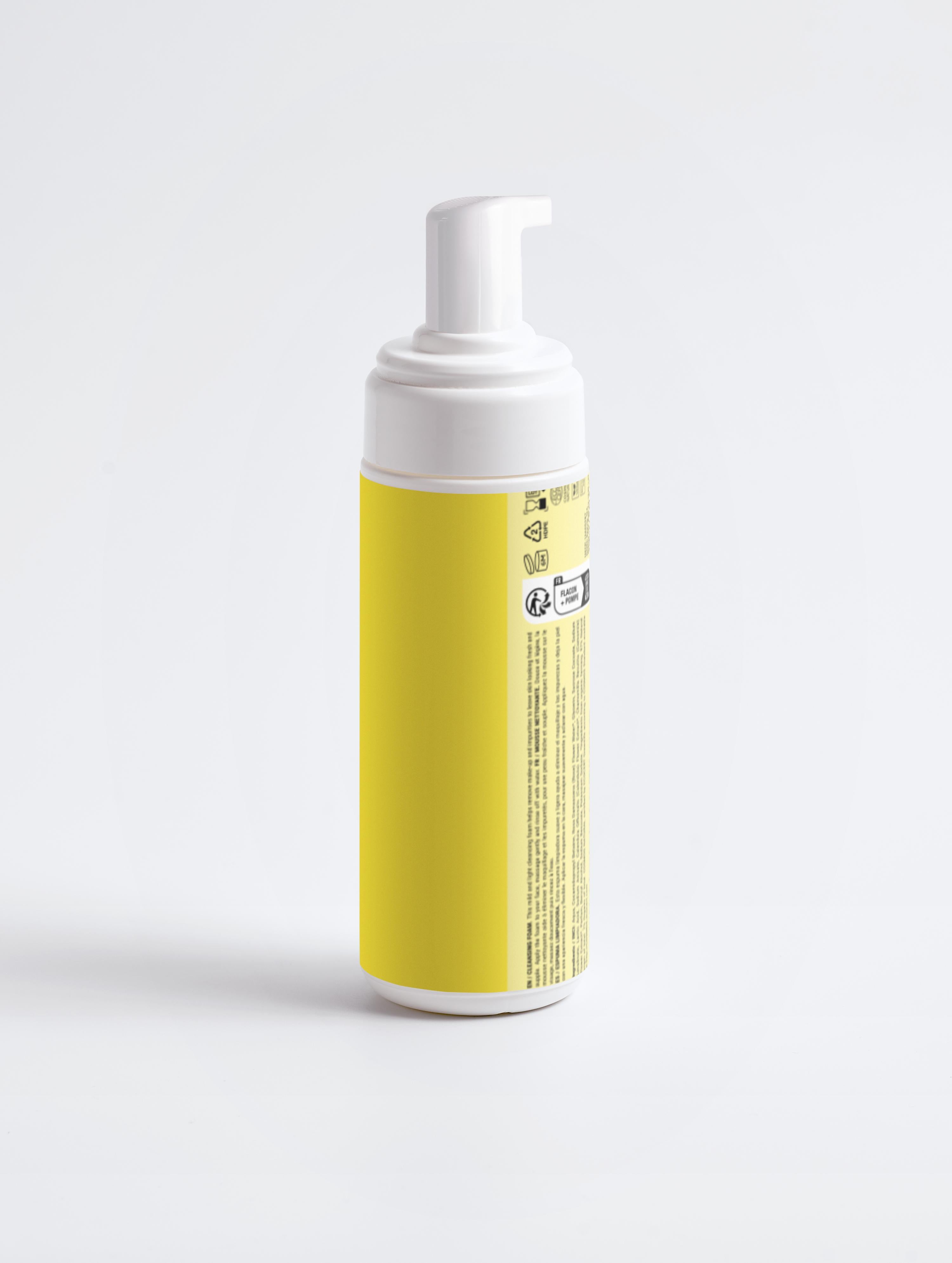 Foam bottle with yellow label on a light gray background