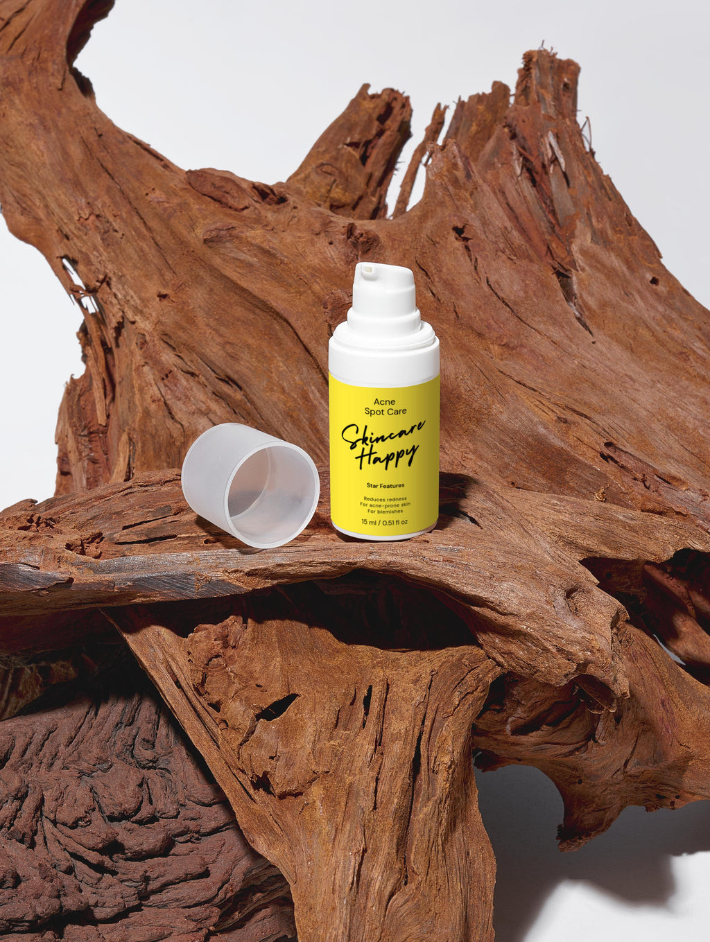 Skincare Happy bottle with a yellow label on a wooden surface