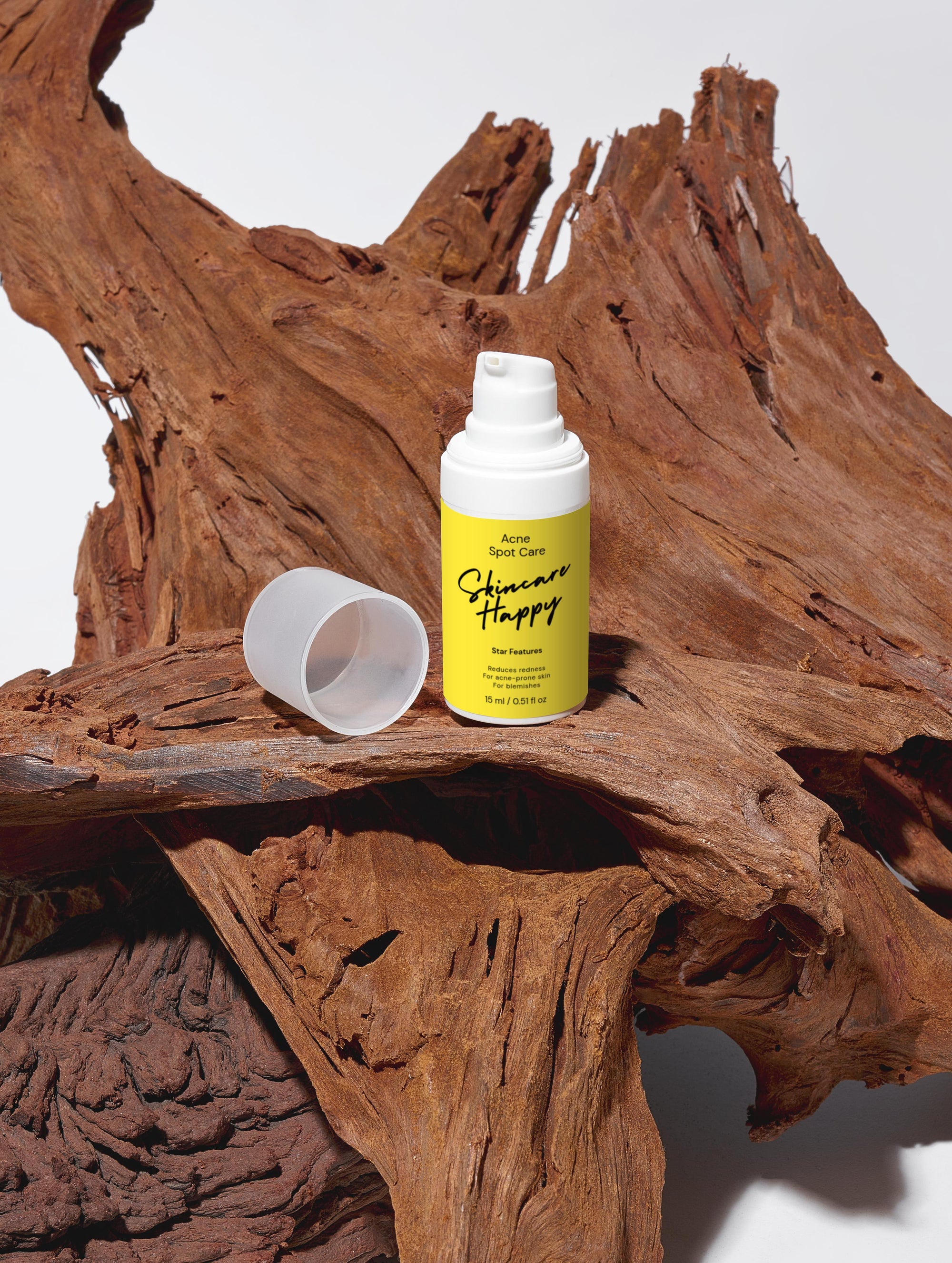 Skincare Happy bottle with a yellow label on a wooden surface