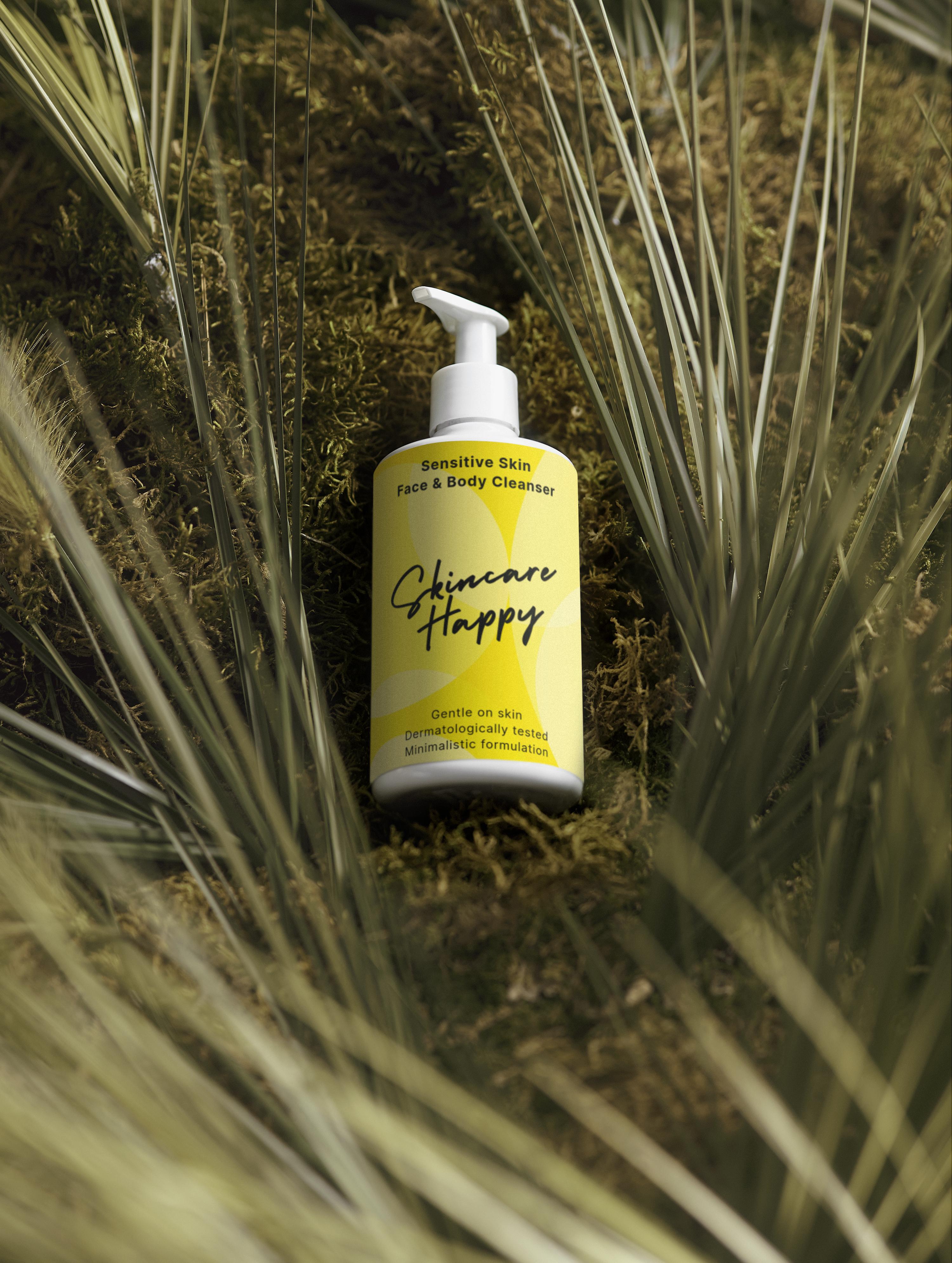 Yellow bottle of 'Skincare Happy' product on a natural background