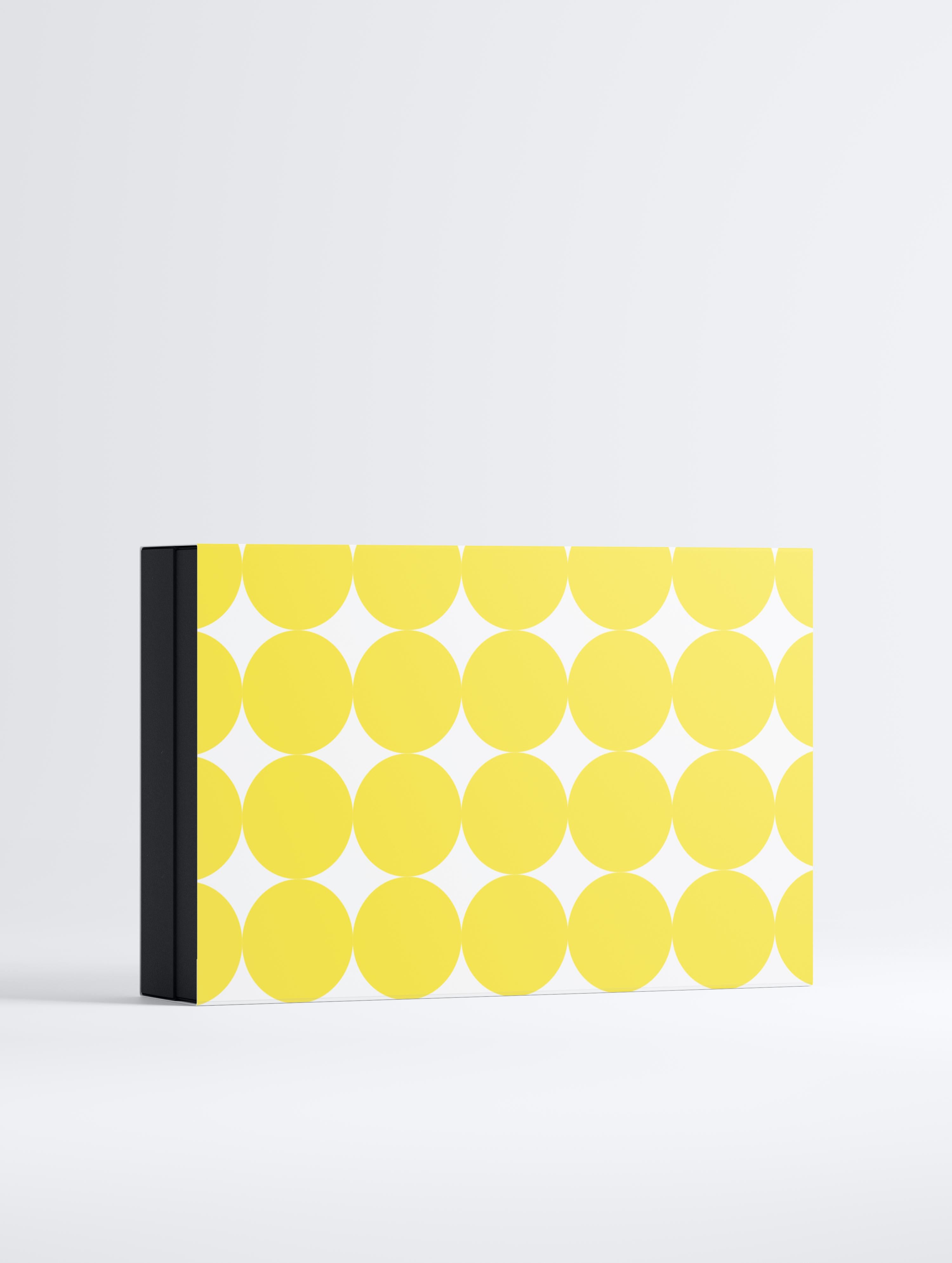 box with yellow circular pattern on a white background