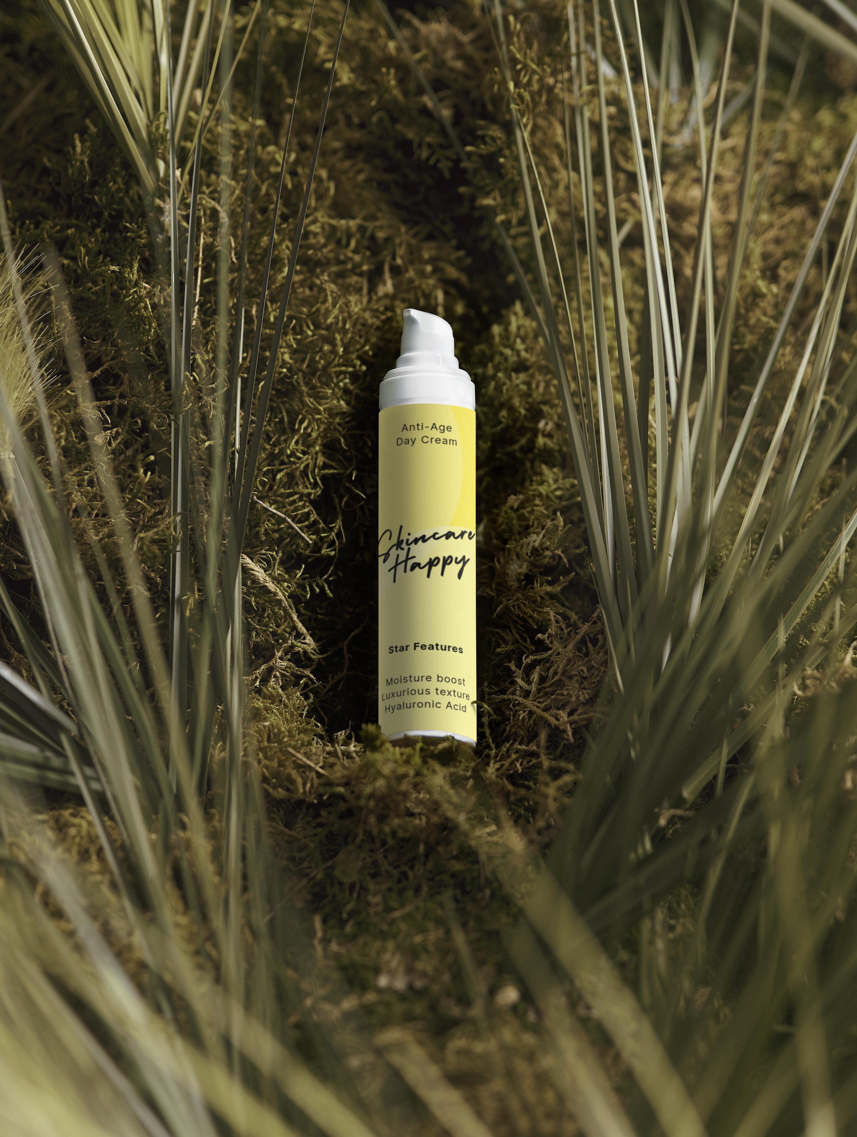 Skincare cream bottle labeled 'Skincare Happy' on a natural background with grass and moss.