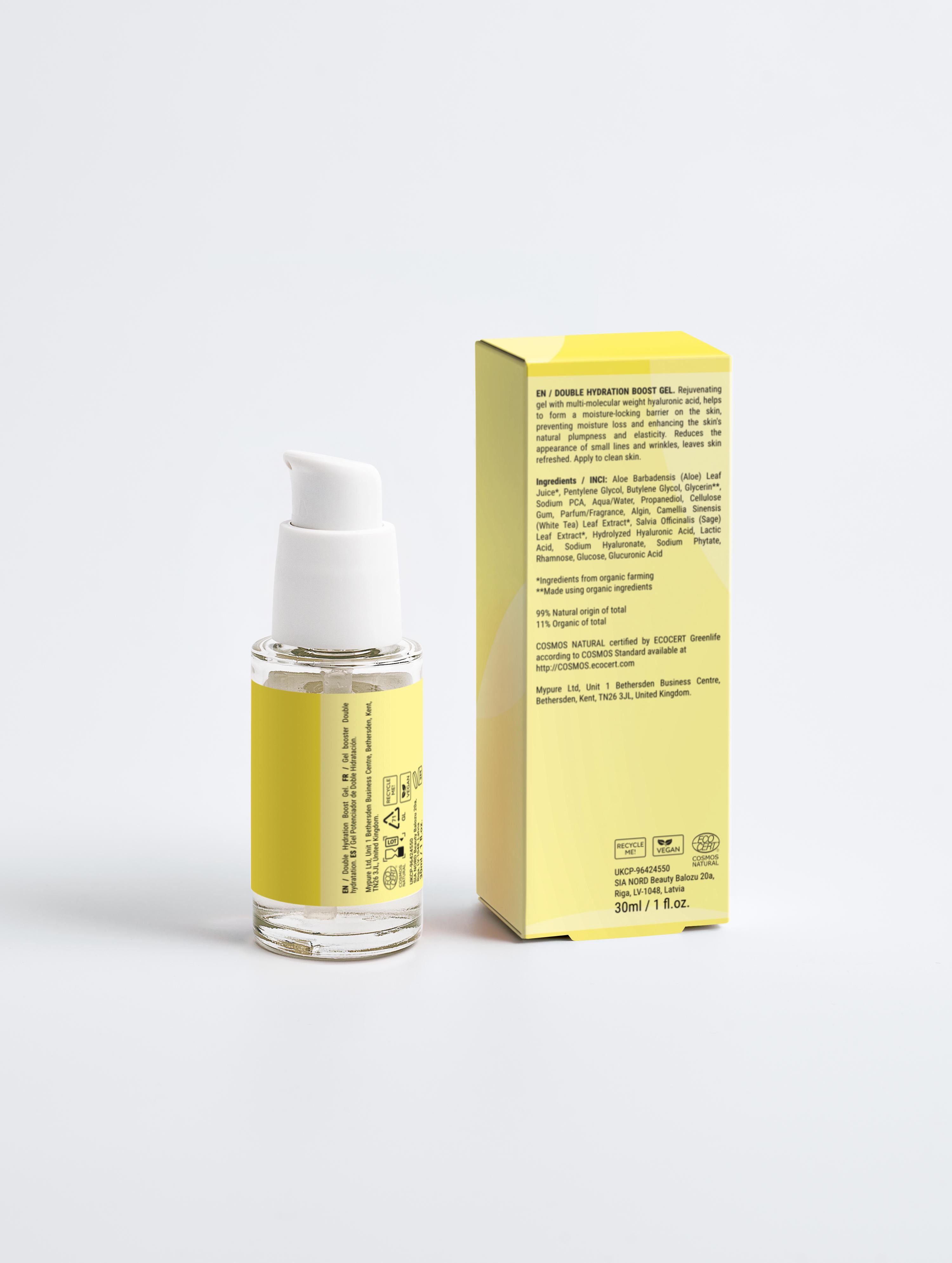 Skincare serum bottle with white cap and yellow label next to its packaging on a light gray background