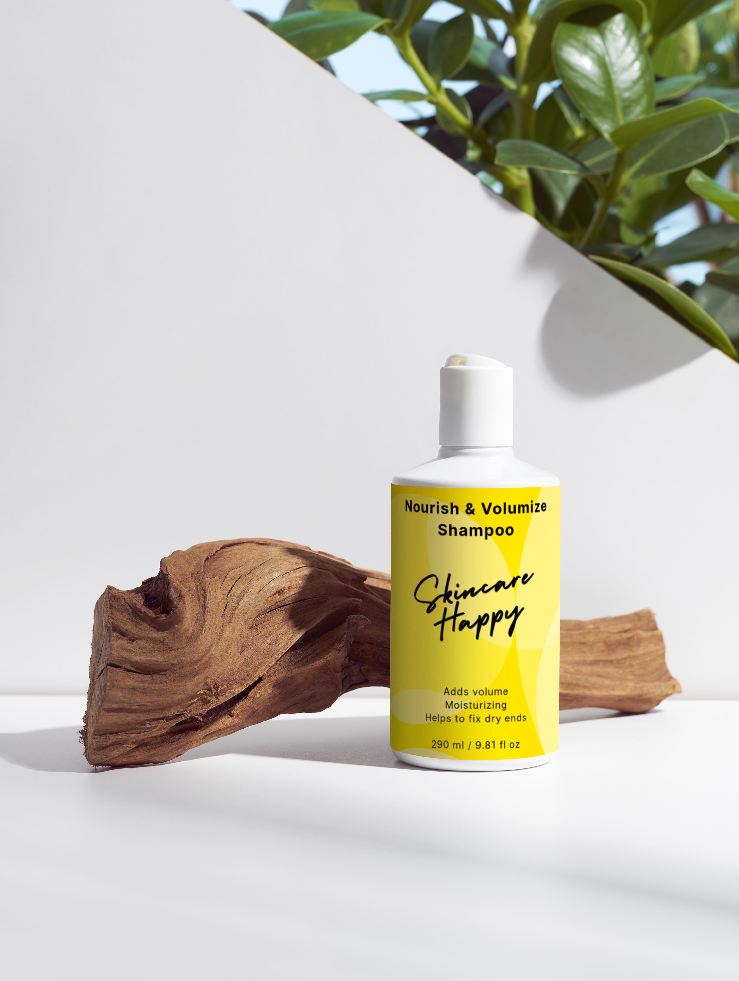 Shampoo bottle labeled 'Nourish & Volumize' by 'Skincare Happy' on a white surface with a wooden log and plant in the background.