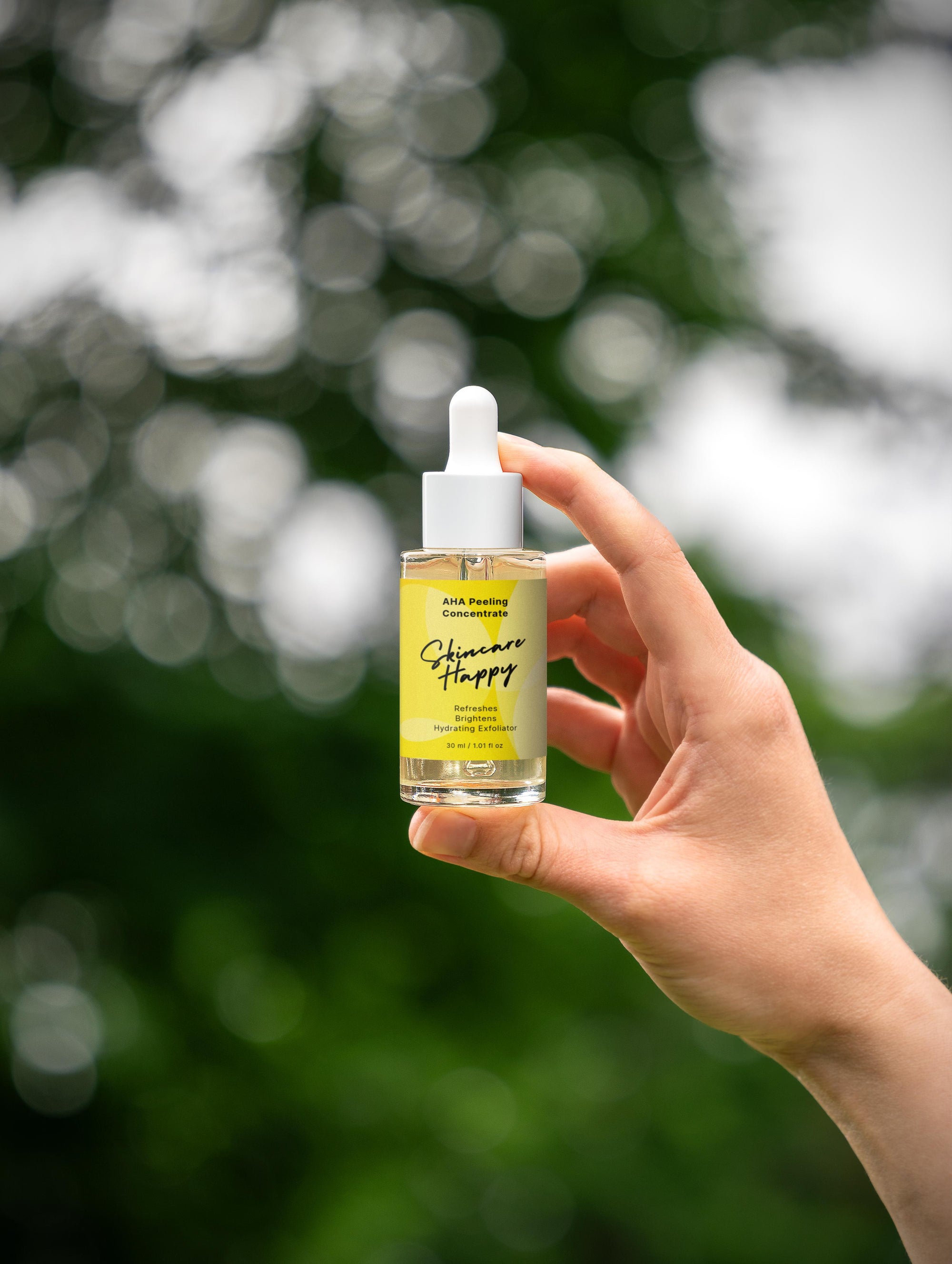 Hand holding a bottle of 'Skincare Happy' product with a blurred green background