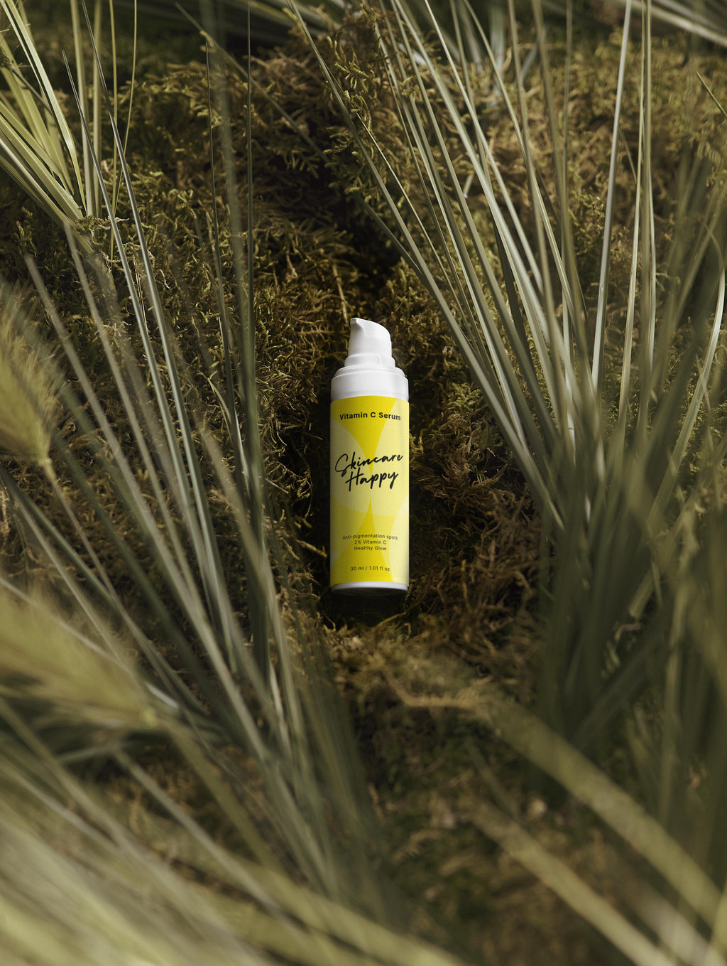 Yellow spray bottle with black text on a grassy background