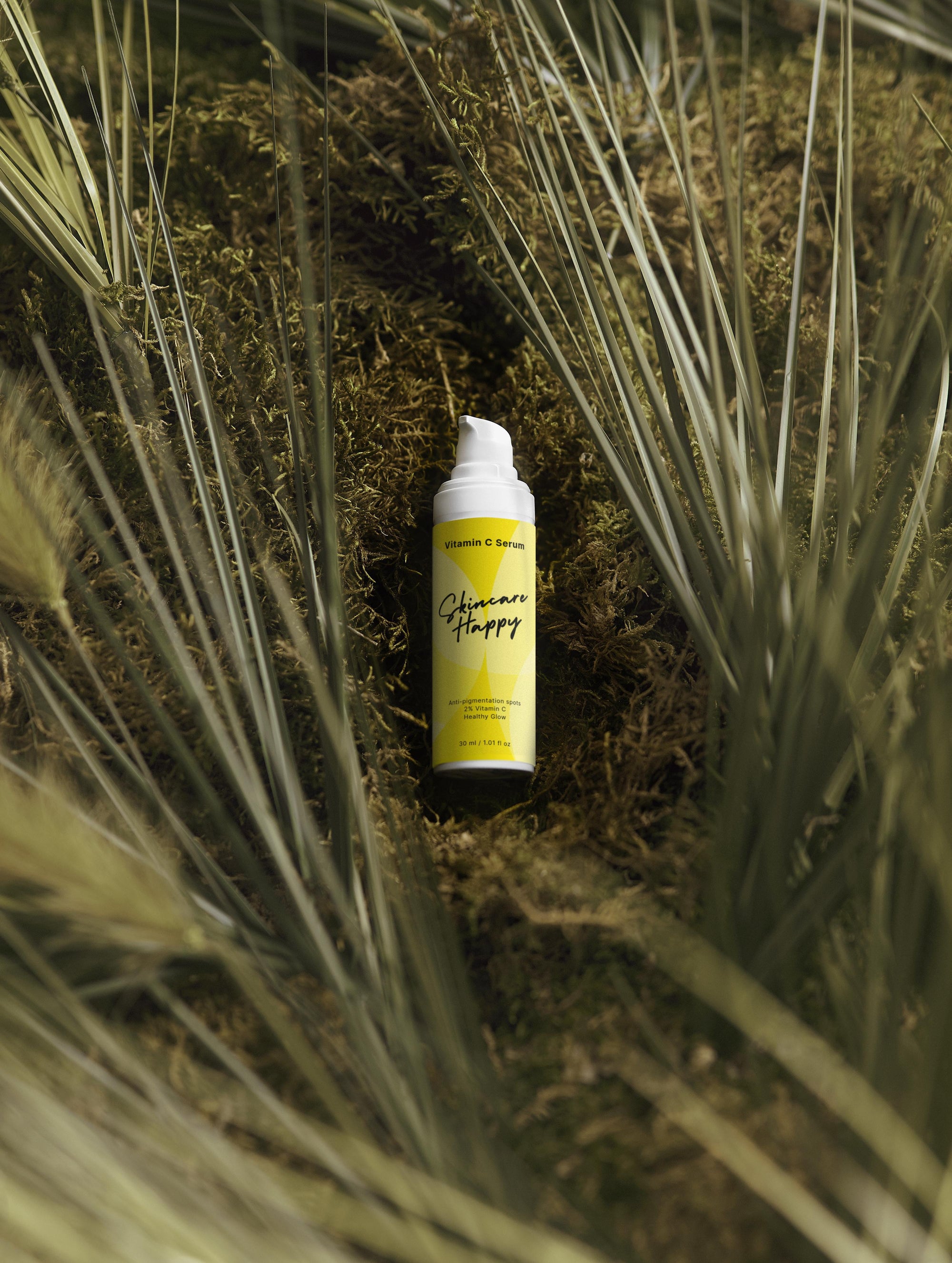 Yellow spray bottle with black text on a grassy background