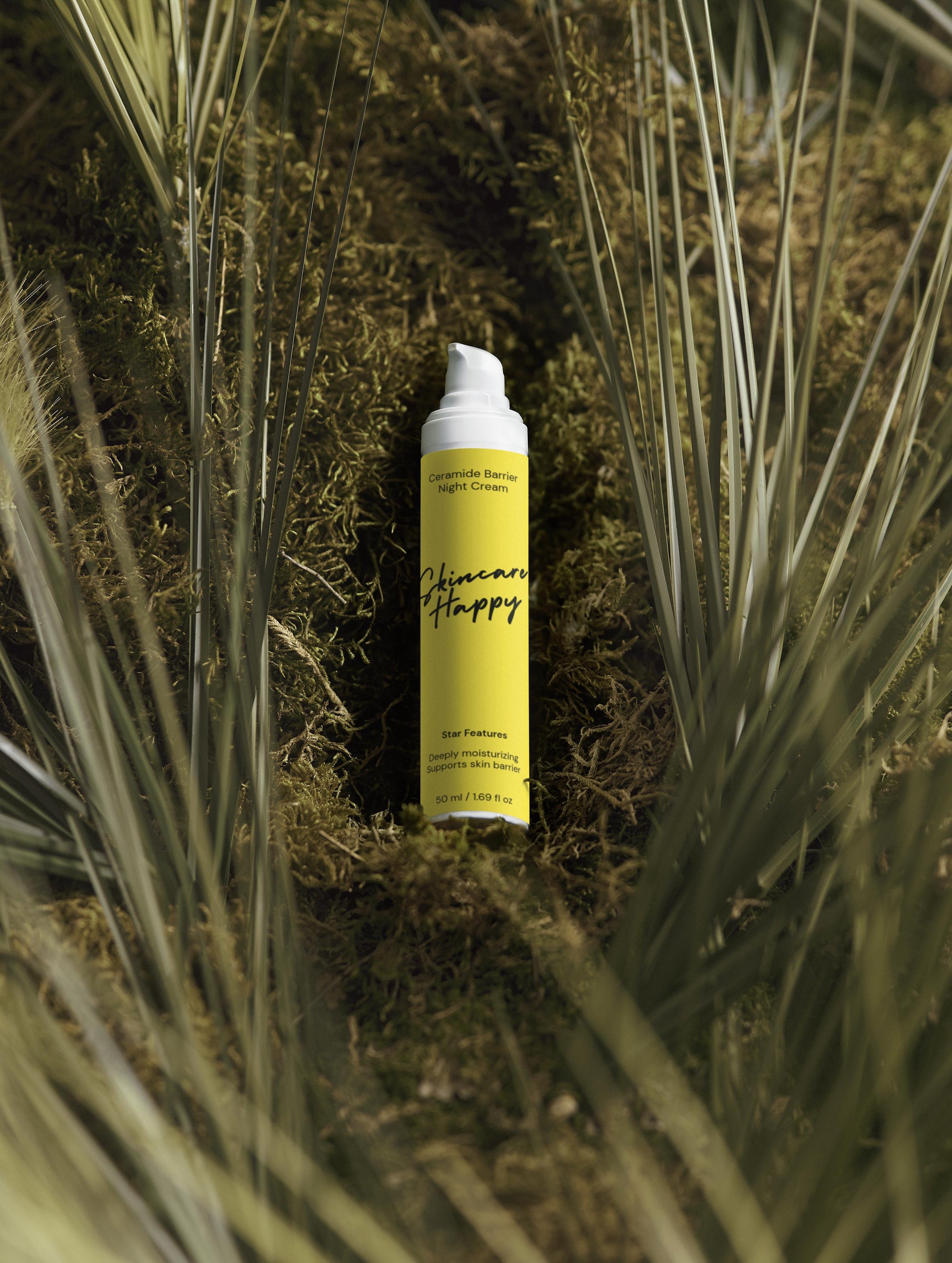 Yellow spray can with black text on a green plant background