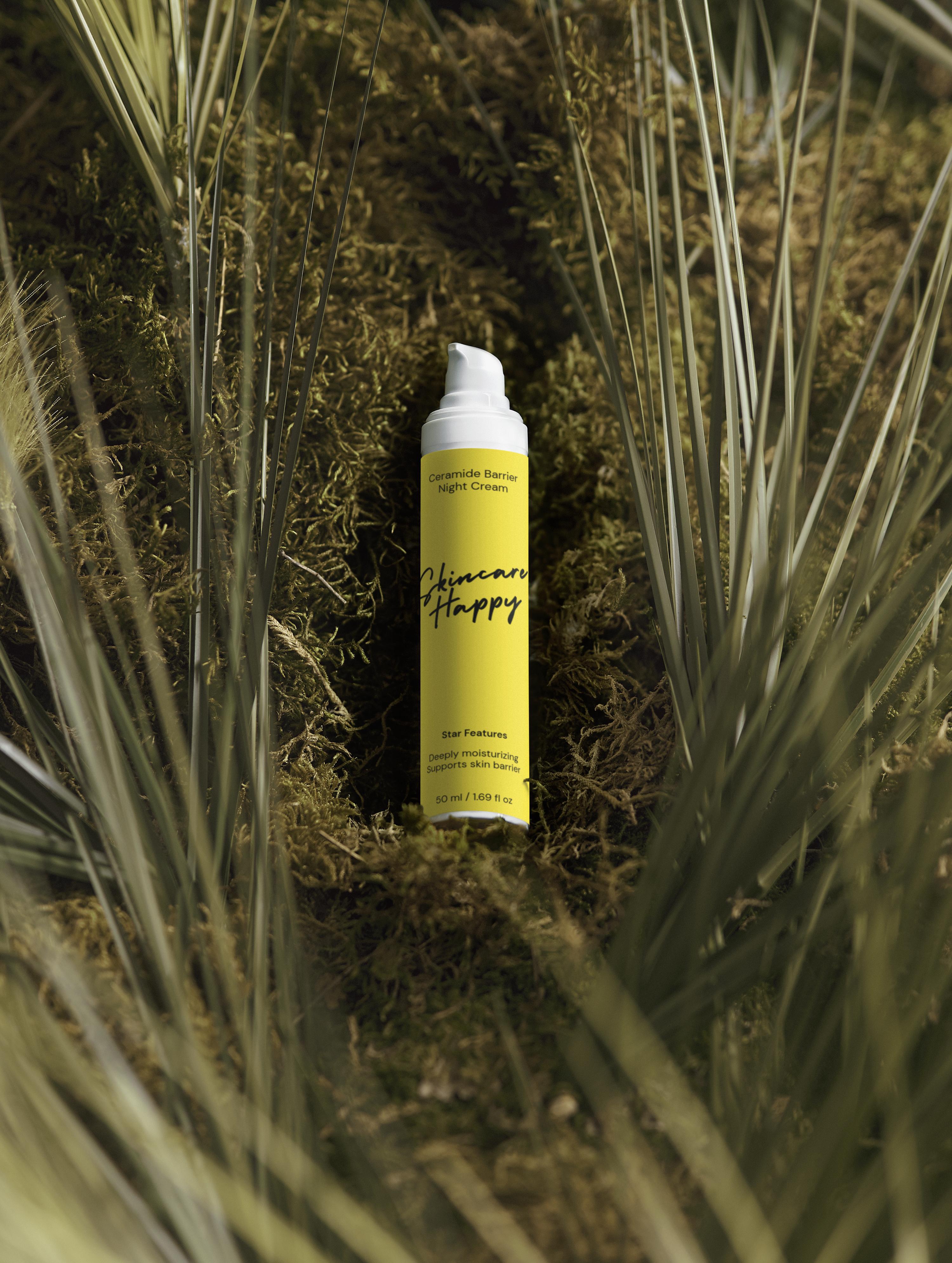 Yellow spray can with black text on a green plant background