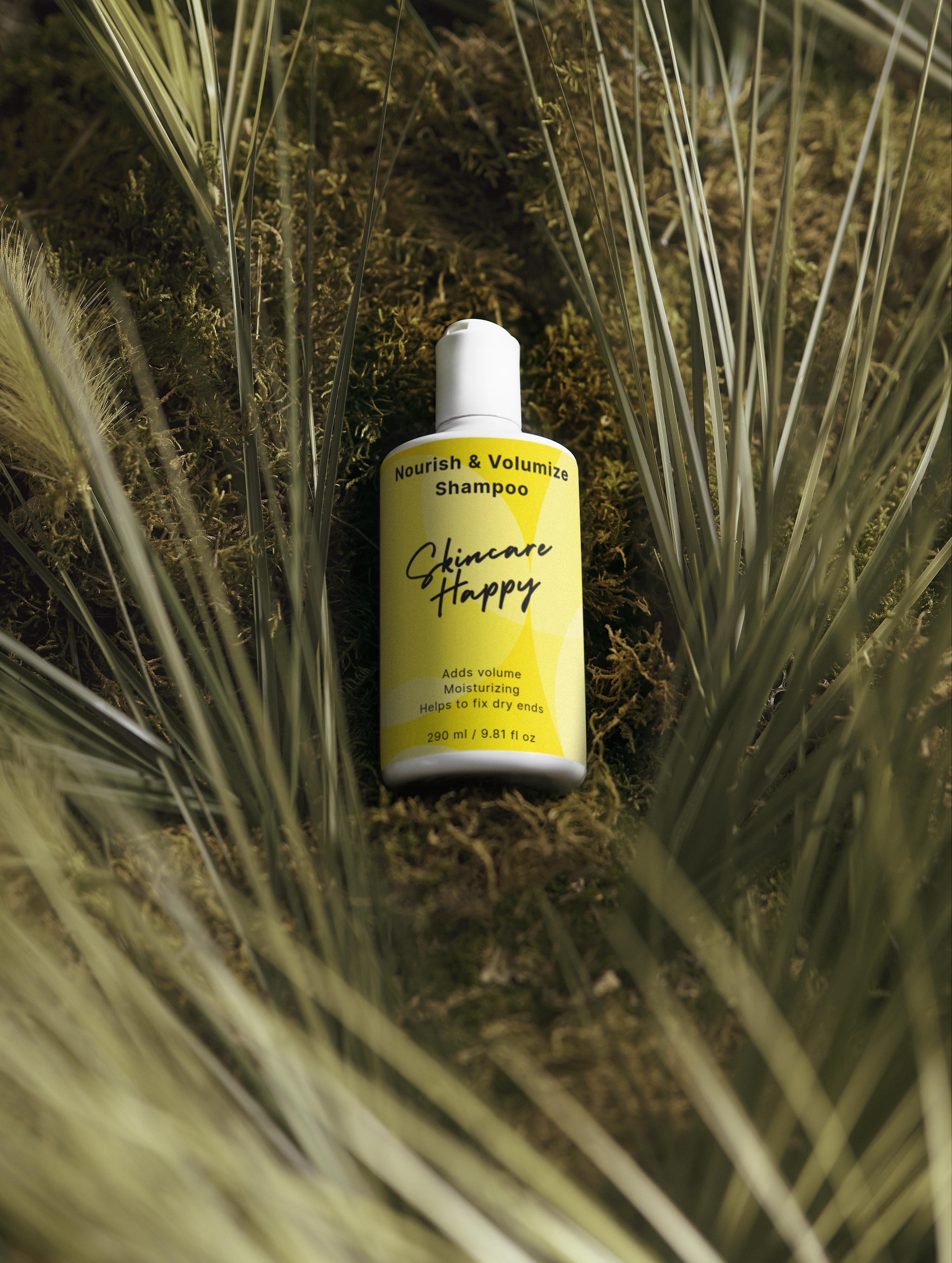 Shampoo bottle labeled 'Skincare Happy' surrounded by grass and plants