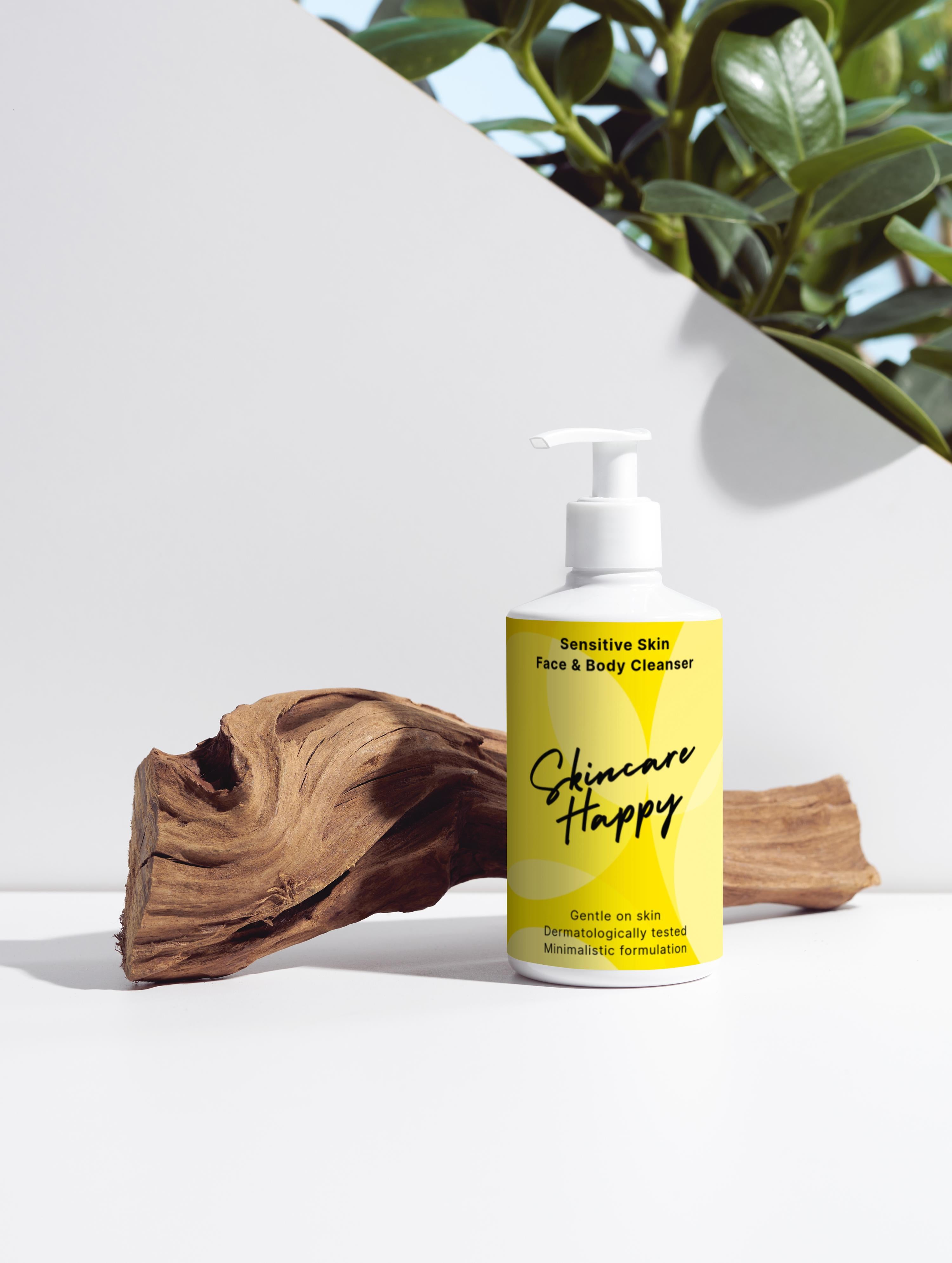 Yellow bottle of 'Skincare Happy' cleanser with a plant and wooden log in the background